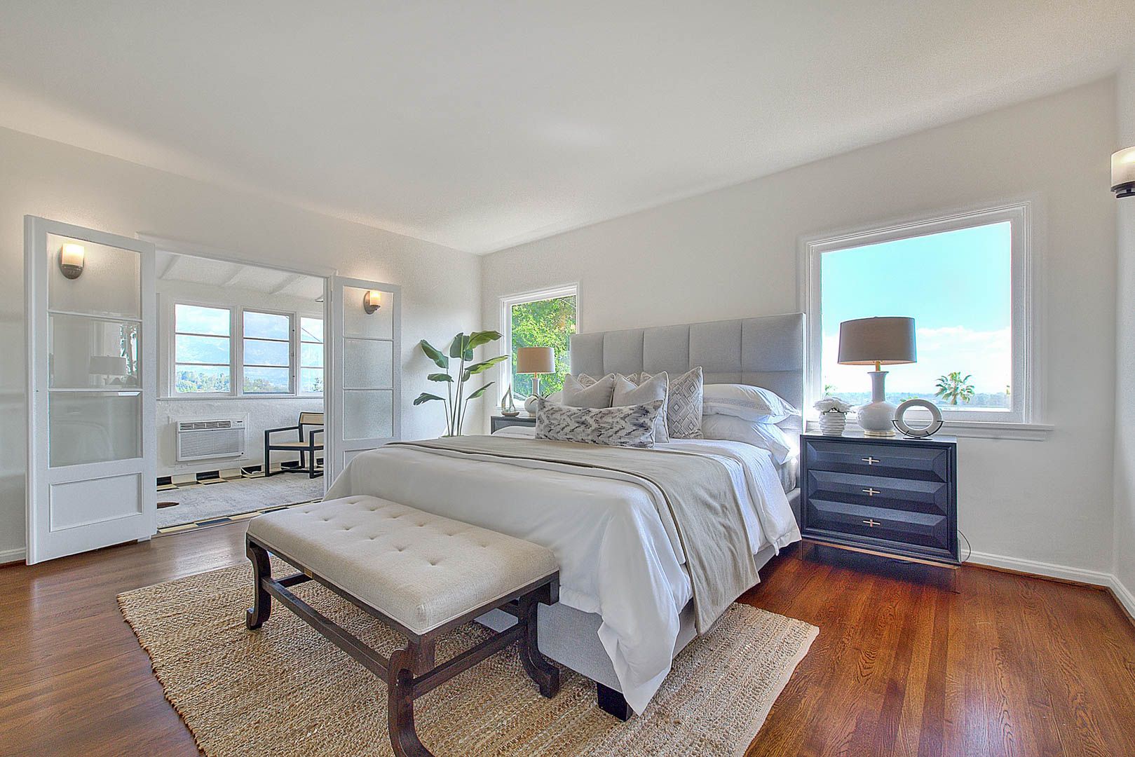 Staged master bedroom with hardwood floors — home staging