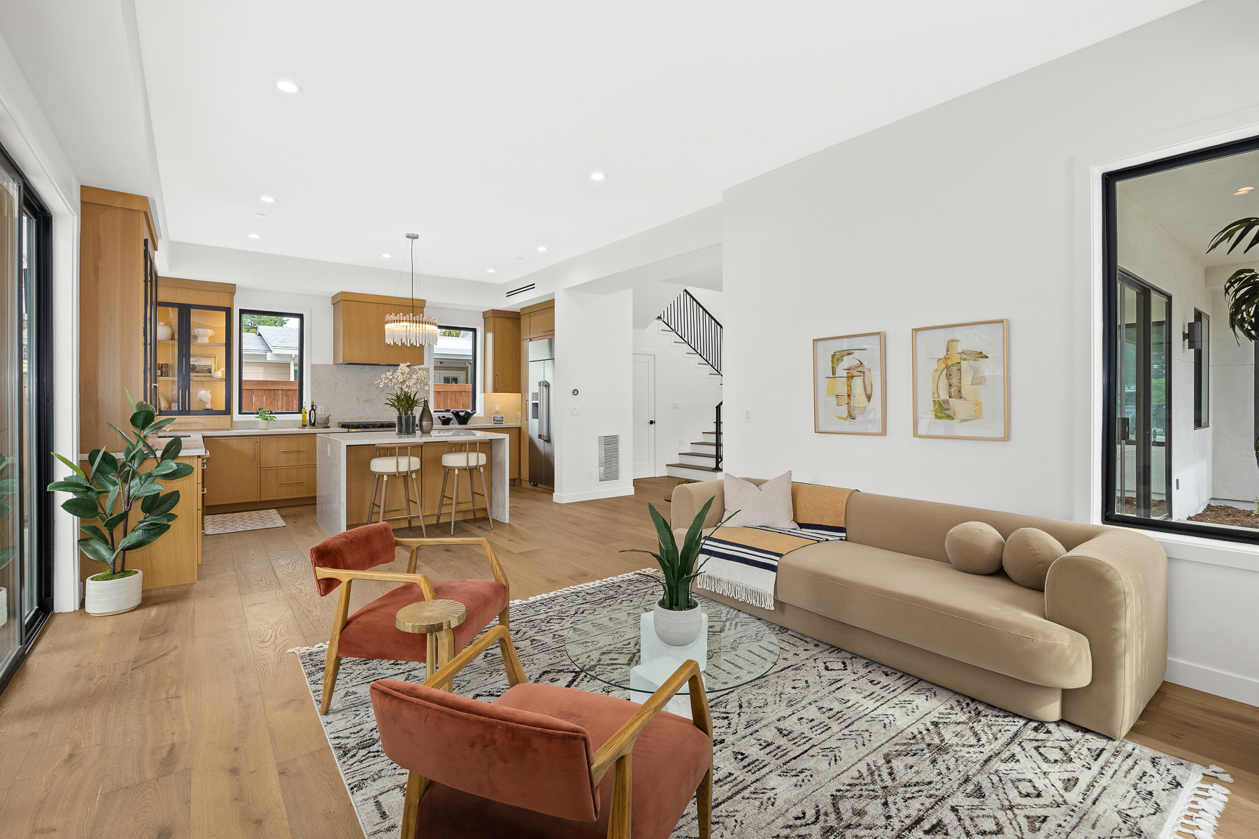 Staged living and kitchen view — new construction home staging